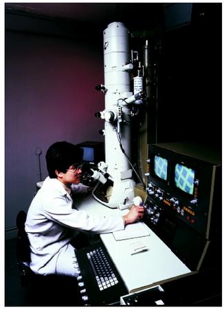 A scientist operating a scanning transmission electron microscope.